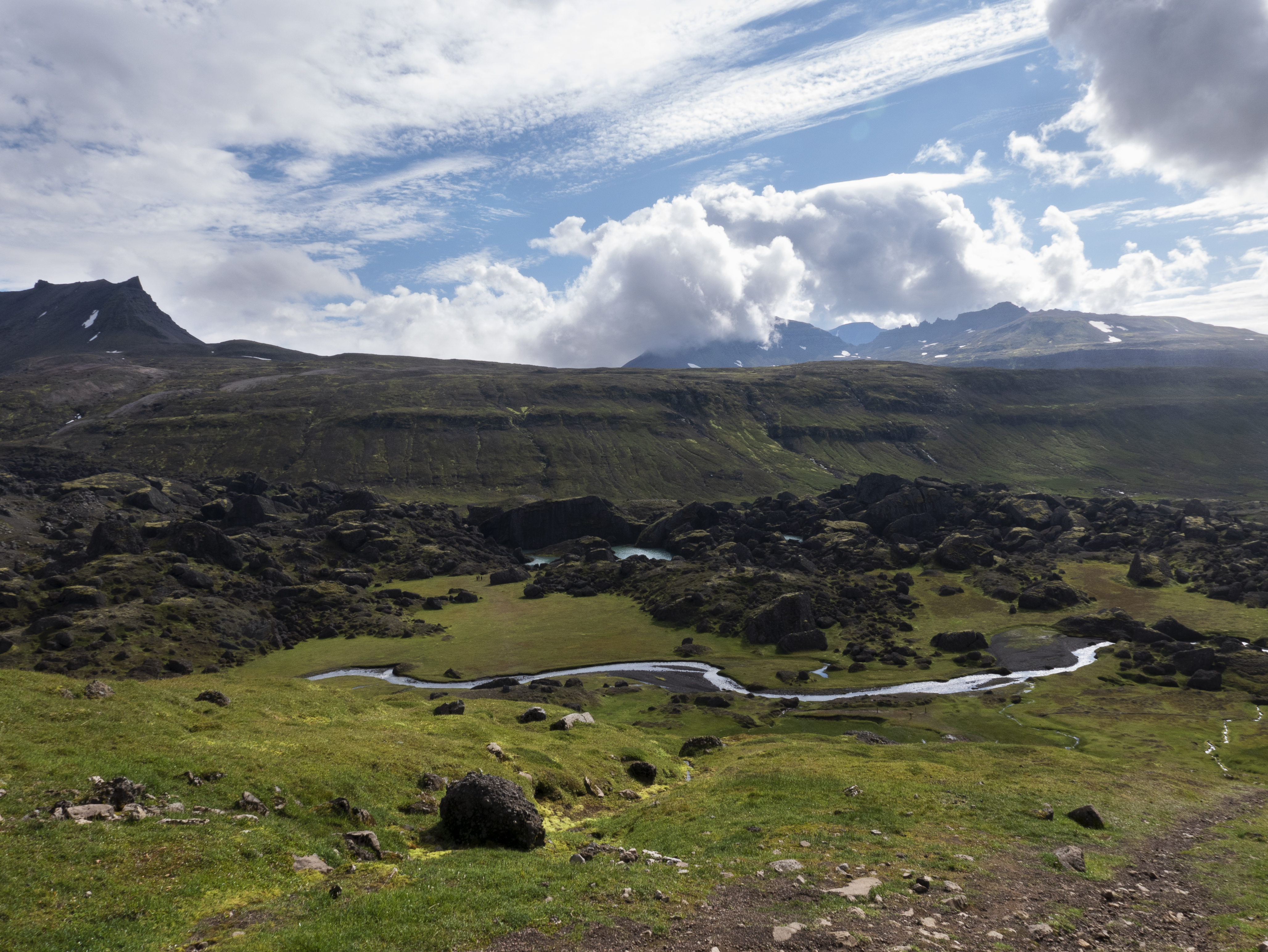 Stórurð is an oasis of meadows, ponds and giant boulders that sits below the jagged peaks of the Dyrfjöll mountains.