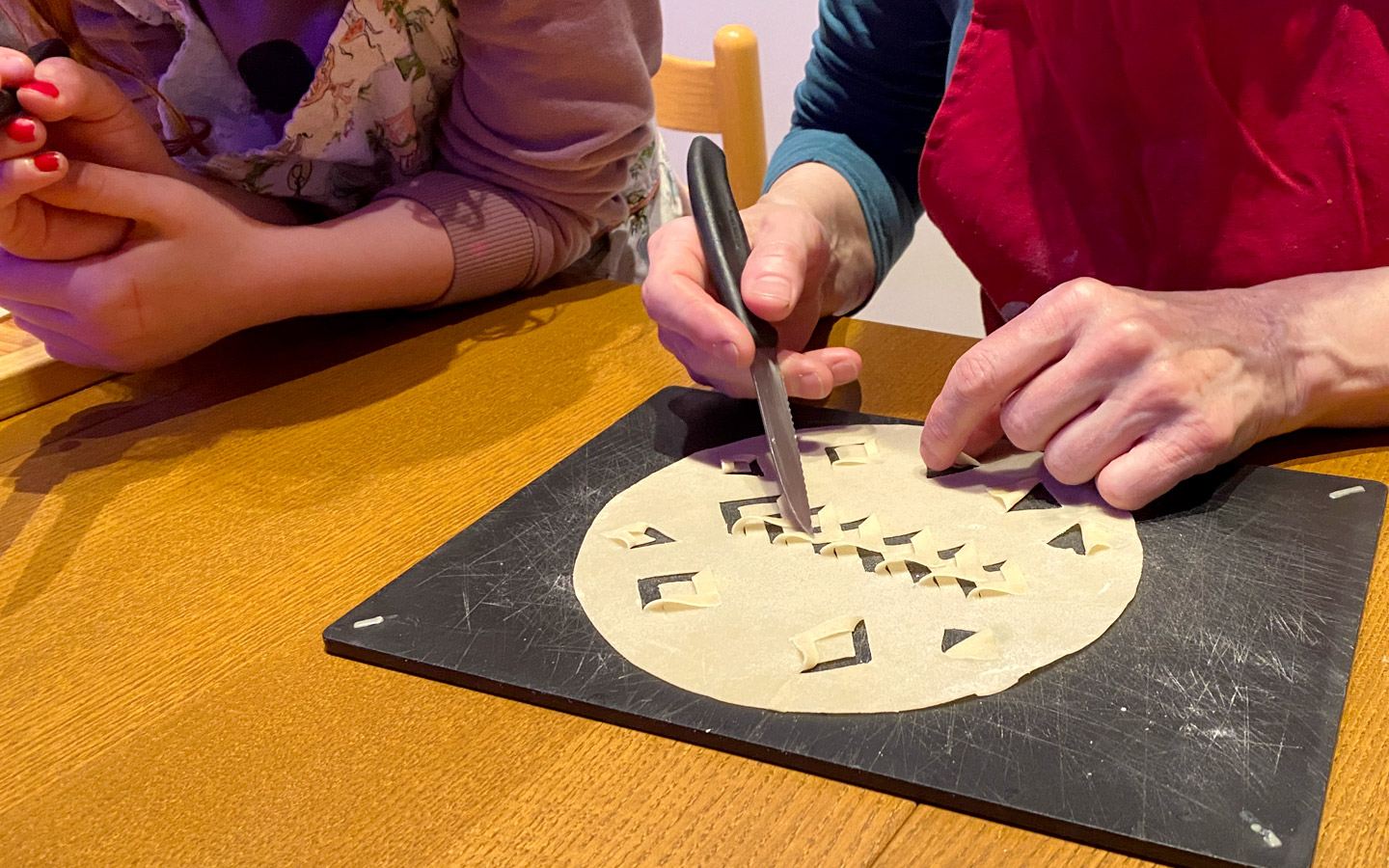 Woman making traditional patterns on Laufabrauð (leafbread)