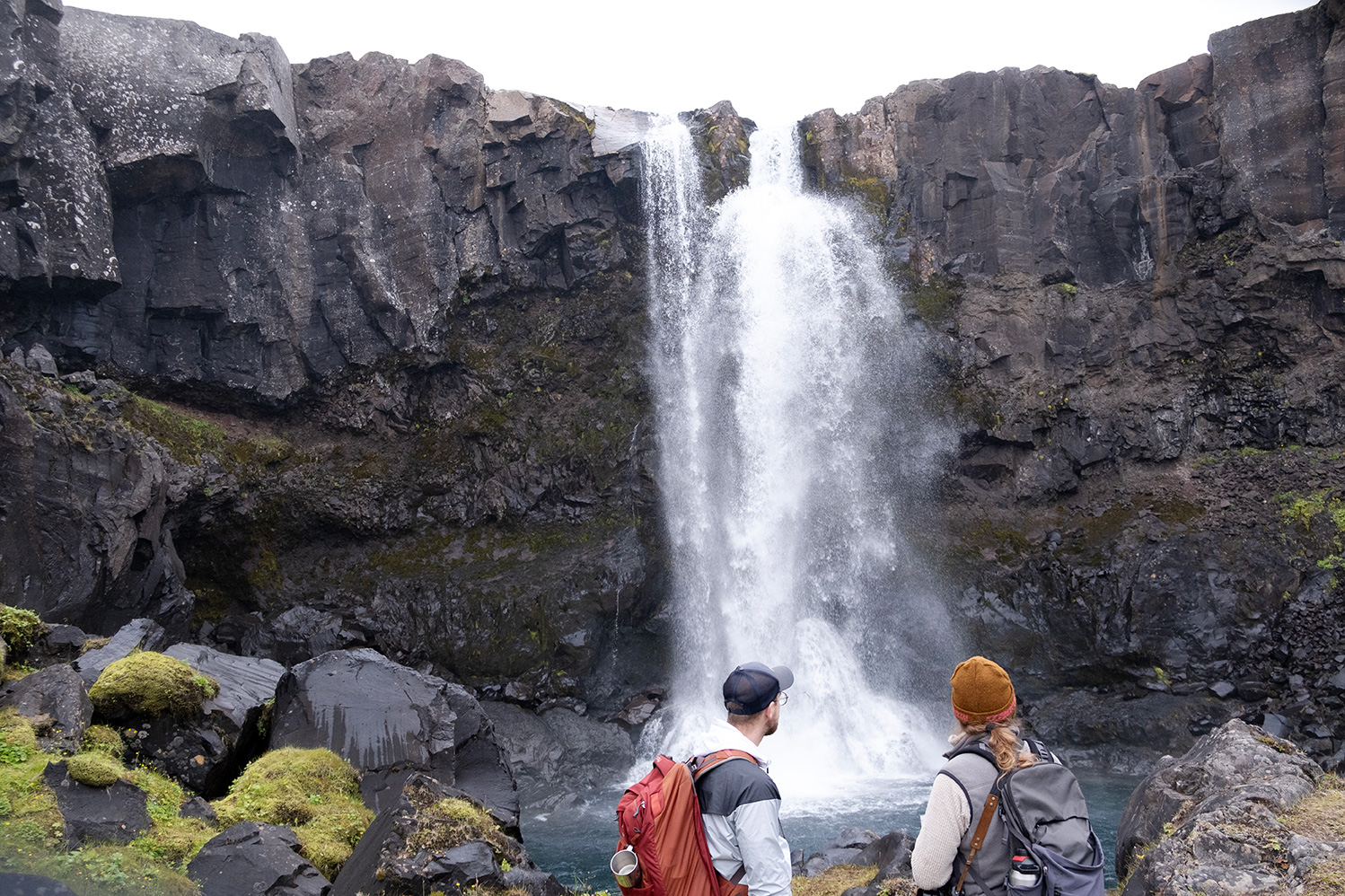 Hikers admiring the beautiful Gufufoss waterfall