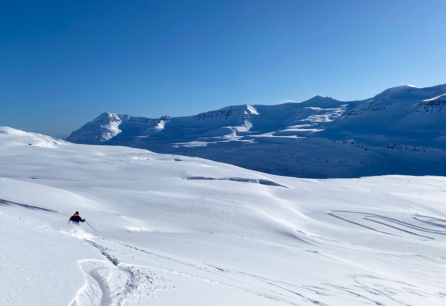 Man skiing in a slope called Austurríki (Switzerland) at Stafdalur ski area
