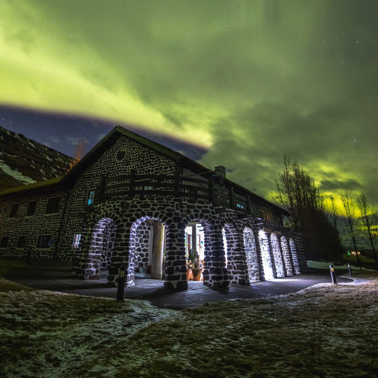 Skriduklaustur at night with in northern lights in the sky